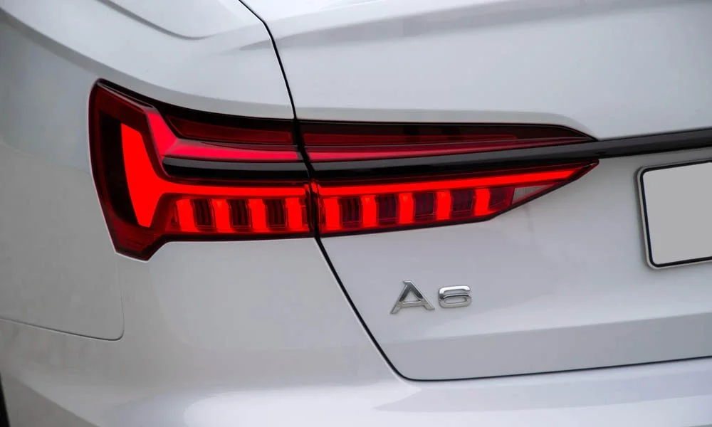 Фото Audi A6 — задние фонари. Рассеиватель фонаря вблизи: компоновка секций габарита, стопа и поворотника Audi A6 — задние фонари