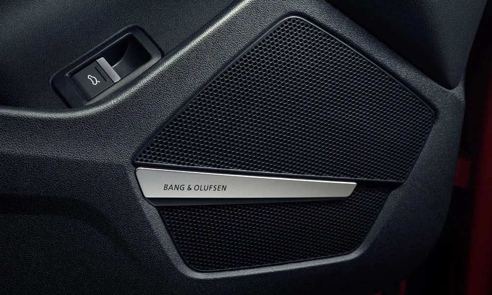 Фото Audi Q5 e-tron (2024) — дверная карта, фото 2. Внутренняя панель двери: сочетание материалов и компоновка управления в красно-чёрной гамме. Мягкая вставка в зоне локтя — то, что чувствуешь каждый день Audi Q5 e-tron (2024) — дверная карта, фото 2
