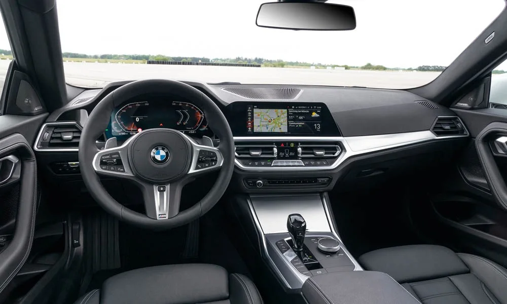 Фото BMW 2 серии — передняя панель. Архитектура передней панели: ярусы, вставки и консоль в тёмной гамме. Минимум физических кнопок — ставка на экранное управление BMW 2 серии — передняя панель
