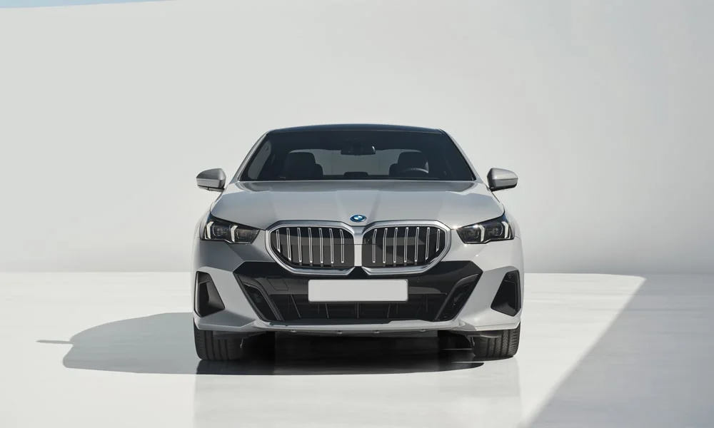 Фото BMW 5 серии (2024) — вид спереди, фото 3. Анфас: пропорции капота, посадка кузова и графика ходовых огней BMW 5 серии (2024) — вид спереди, фото 3