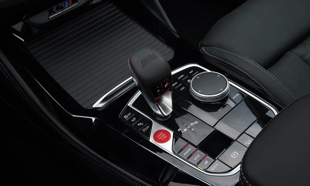 Фото BMW X4 M (2024) — селектор коробки передач. Управление коробкой: компактный селектор освобождает место на тоннеле. Автохолд удерживает машину на светофоре без ноги на тормозе BMW X4 M (2024) — селектор коробки передач