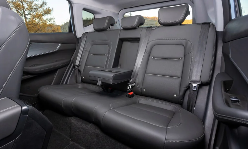 Фото Chery Tiggo 7 Pro Plug-in Hybrid (2023) — задние сиденья, фото 2. Посадка второго ряда: подголовники и подлокотник. Спинки складываются под длинные грузы у большинства версий Chery Tiggo 7 Pro Plug-in Hybrid (2023) — задние сиденья, фото 2