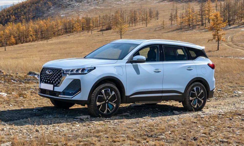 Фото Chery Tiggo 7 Pro Plug-in Hybrid (2023) — вид сбоку, фото 5. Сбоку читаются линия остекления и характер выштамповок на белом кузове. Хромированные или чёрные молдинги окон отличают комплектации Chery Tiggo 7 Pro Plug-in Hybrid (2023) — вид сбоку, фото 5