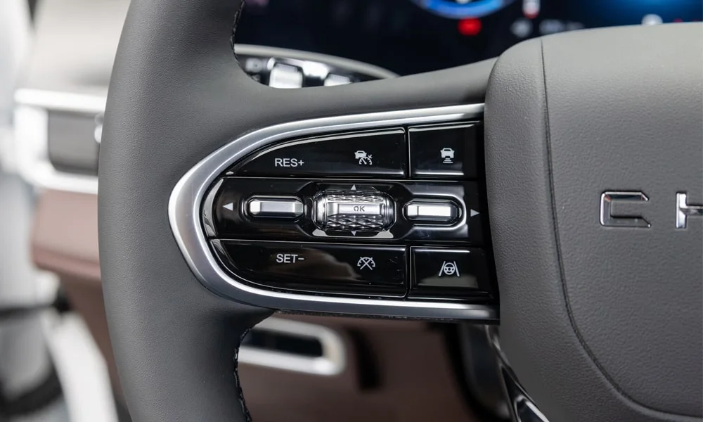 Фото Chery Tiggo 8 Pro Max (2022) — руль. Обшивка обода и компоновка спиц крупным планом. Клавиши на спицах управляют медиа, круизом и ассистентами — руки остаются на руле Chery Tiggo 8 Pro Max (2022) — руль