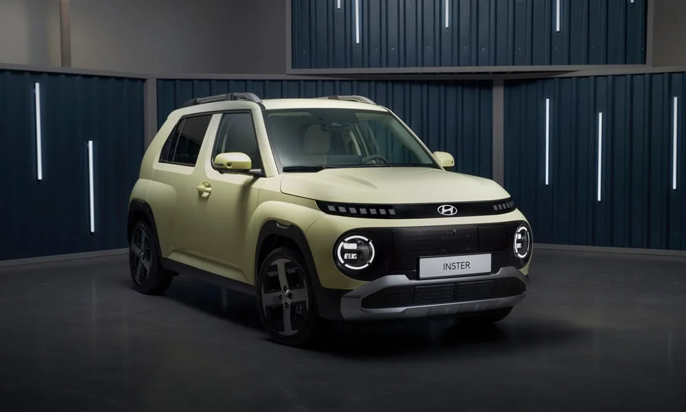 Фото Hyundai Inster — вид спереди, фото 7. Бежевый кузов, строгая симметрия оптики — базовый ракурс знакомства с дизайном. Рисунок ходовых огней — подпись модели, по нему её узнают в потоке Hyundai Inster — вид спереди, фото 7
