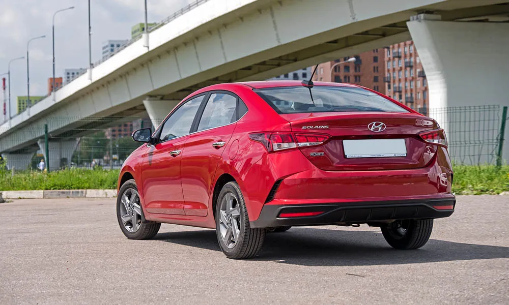 Фото Hyundai Solaris — вид сзади, фото 6. Красный кузов сзади — фонари и бампер определяют ночной образ модели Hyundai Solaris — вид сзади, фото 6