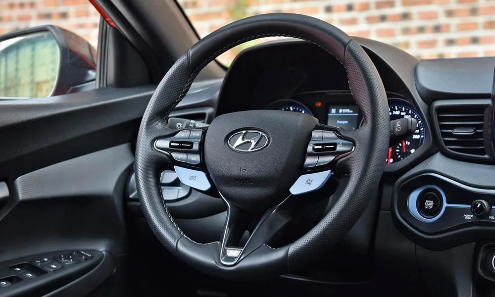 Фото Hyundai Veloster N (2024) — руль. Обшивка обода и компоновка спиц крупным планом. Обогрев обода — опция, которую оценят зимой Hyundai Veloster N (2024) — руль