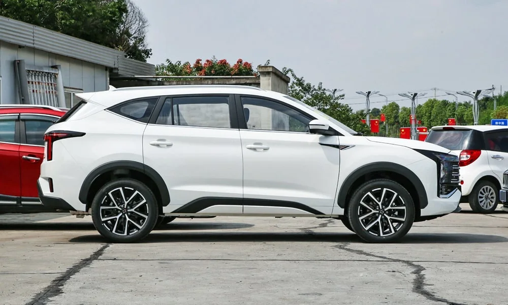 Фото JAC X8 Plus (2024) — вид сбоку, фото 3. Профиль в белом цвете: соотношение колёсной базы и свесов. Хромированные или чёрные молдинги окон отличают комплектации JAC X8 Plus (2024) — вид сбоку, фото 3