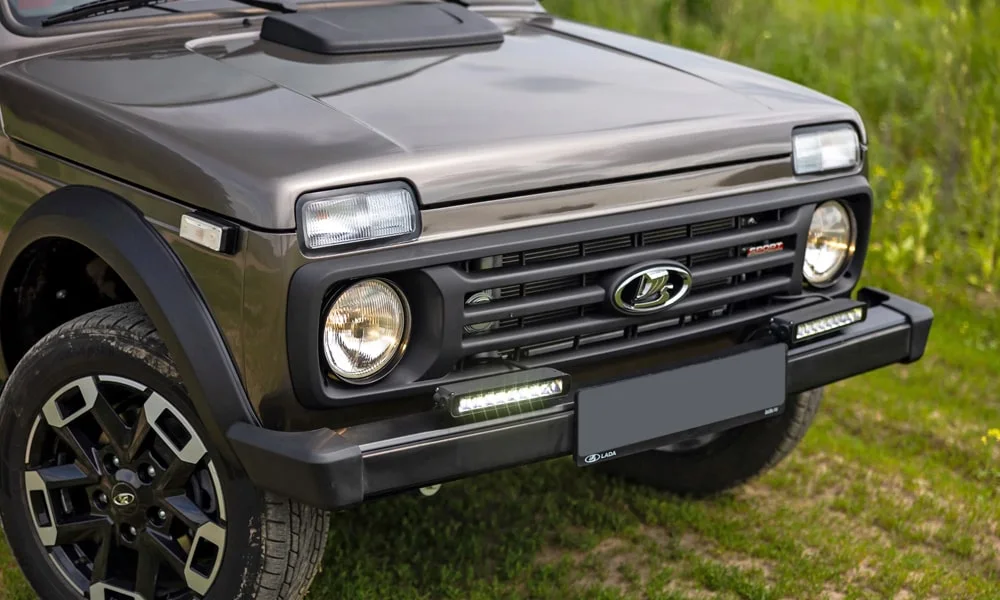 Фото LADA Niva Sport (2025) — вид спереди, фото 14. Анфас: пропорции капота, посадка кузова и графика ходовых огней. Рисунок ходовых огней — подпись модели, по нему её узнают в потоке LADA Niva Sport (2025) — вид спереди, фото 14