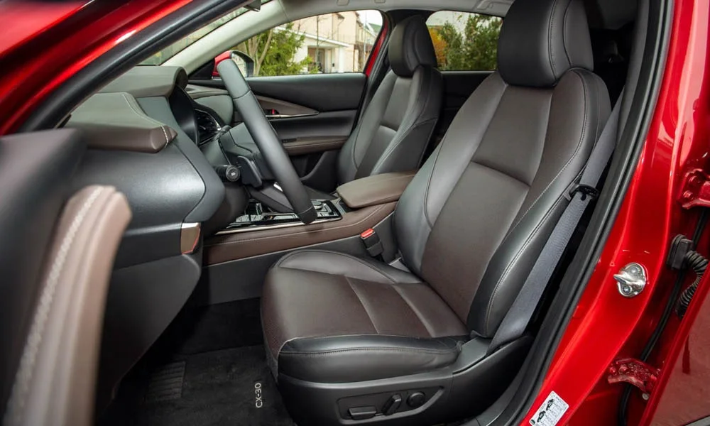 Фото Mazda CX-30 — интерьер. Общий план салона: архитектура панели, консоль и кресла. Уровень отделки читается по стыкам панелей и мягким поверхностям в зонах касания Mazda CX-30 — интерьер