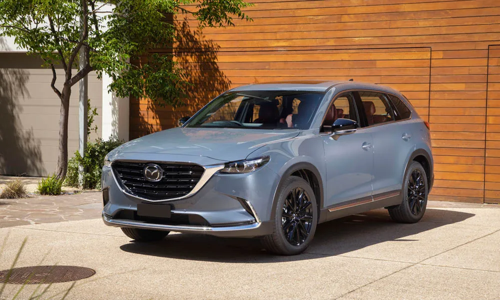 Фото Mazda CX-9 — вид спереди, фото 8. Серый кузов, строгая симметрия оптики — базовый ракурс знакомства с дизайном Mazda CX-9 — вид спереди, фото 8