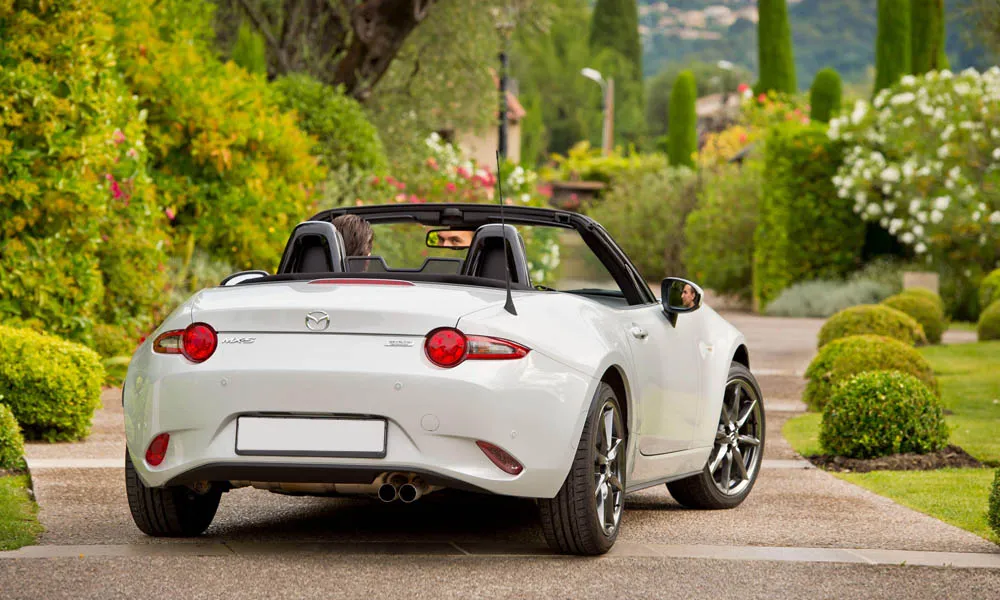 Фото Mazda MX-5 — вид сзади, фото 7. Корма в белом цвете: графика фонарей и пластика пятой двери. Светодиодная полоса или раздельные секции — задняя оптика стала главным украшением кормы Mazda MX-5 — вид сзади, фото 7