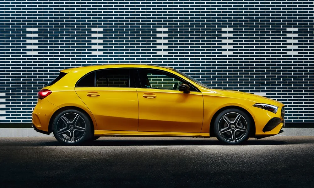 Фото Mercedes-Benz A-Class (2024) — вид сбоку. Жёлтый кузов в профиль — пропорции, высота посадки и дизайн дисков. Длинная база — простор второго ряда; короткие свесы упрощают парковку Mercedes-Benz A-Class (2024) — вид сбоку