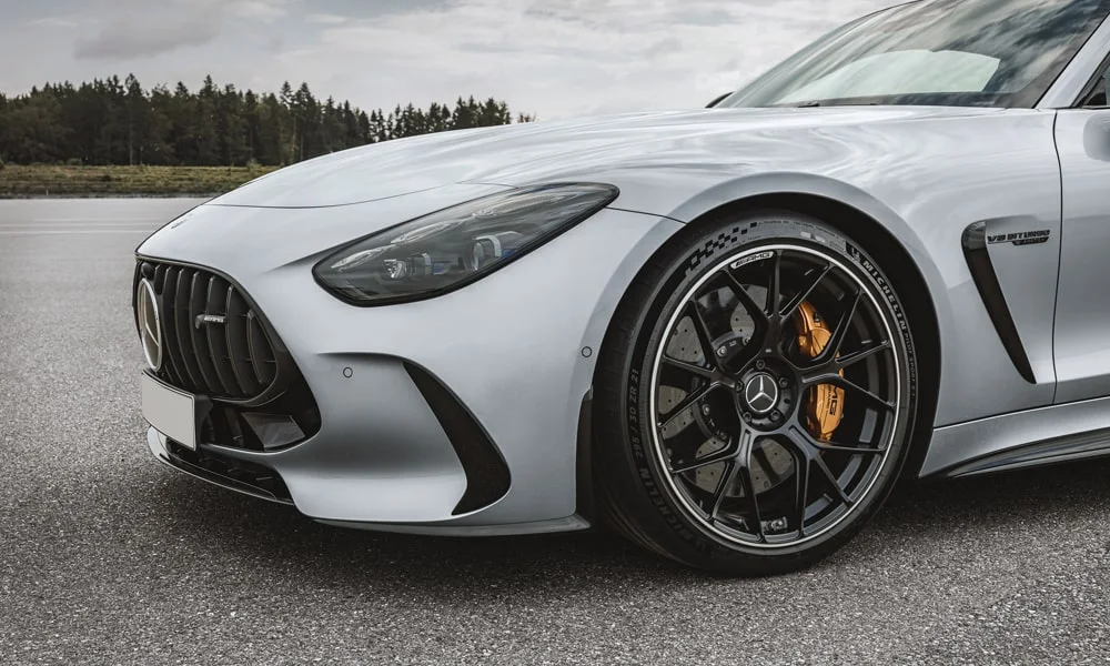 Фото Mercedes-Benz AMG GT (2024) — вид спереди, фото 12. Анфас: пропорции капота, посадка кузова и графика ходовых огней. Рисунок ходовых огней — подпись модели, по нему её узнают в потоке Mercedes-Benz AMG GT (2024) — вид спереди, фото 12