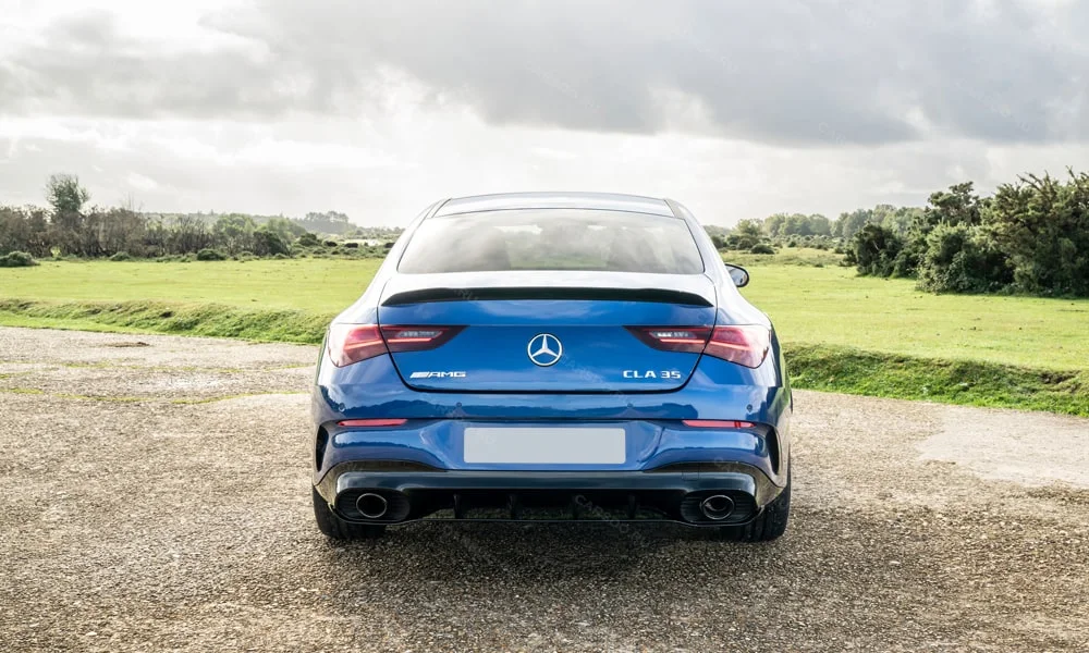 Фото Mercedes-Benz CLA (2024) — вид сзади, фото 2. Синий кузов сзади — фонари и бампер определяют ночной образ модели Mercedes-Benz CLA (2024) — вид сзади, фото 2