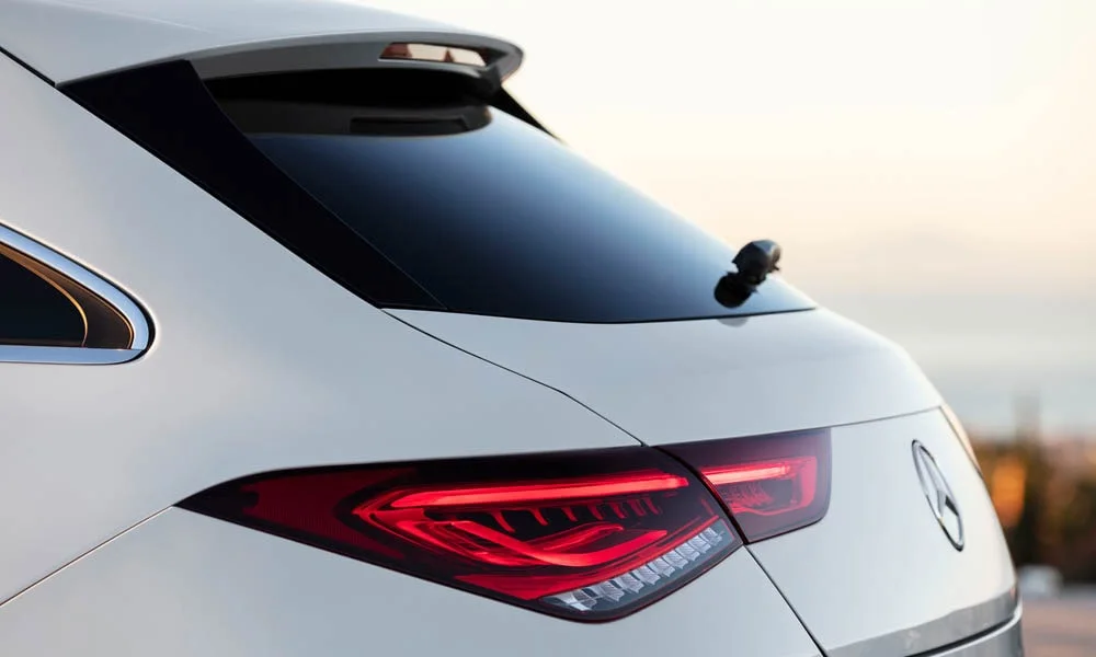 Фото Mercedes-Benz CLA — вид сзади, фото 21. Линия крыши, стойки и задняя дверь в белом исполнении. Насадки выхлопа или их имитация внизу бампера различают версии Mercedes-Benz CLA — вид сзади, фото 21