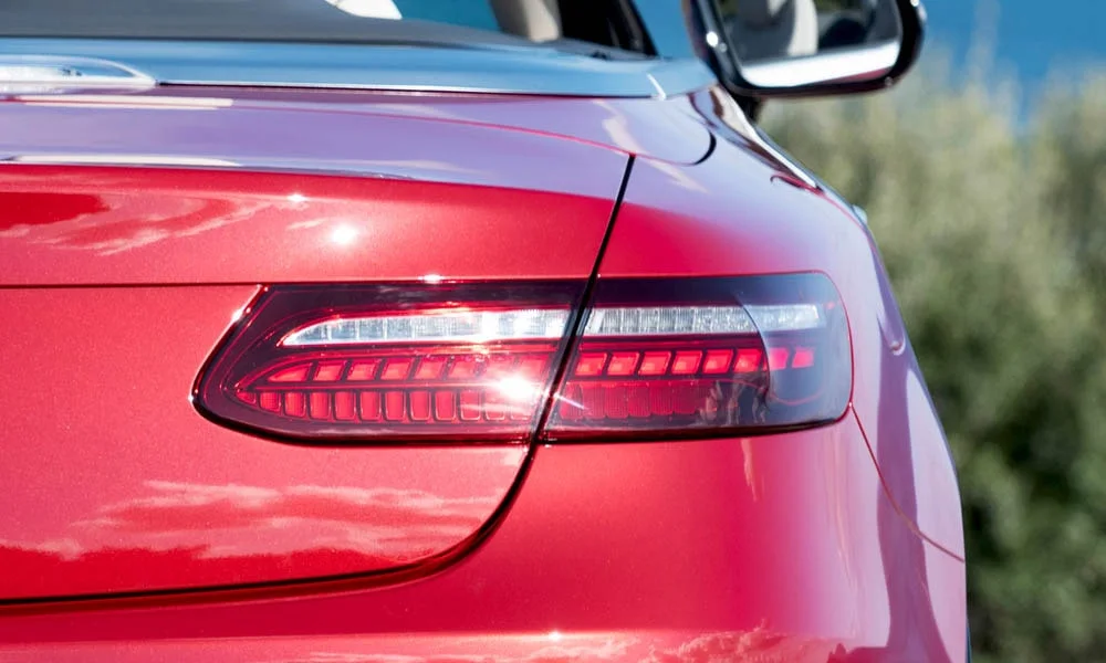Фото Mercedes-Benz E-Class — задние фонари. Графика секций крупным планом — ночная подпись модели. Динамические поворотники с бегущей индикацией встречаются в старших комплектациях Mercedes-Benz E-Class — задние фонари
