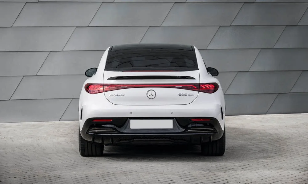 Фото Mercedes-Benz EQE (2024) — вид сзади, фото 2. Белый кузов сзади — фонари и бампер определяют ночной образ модели. Насадки выхлопа или их имитация внизу бампера различают версии Mercedes-Benz EQE (2024) — вид сзади, фото 2