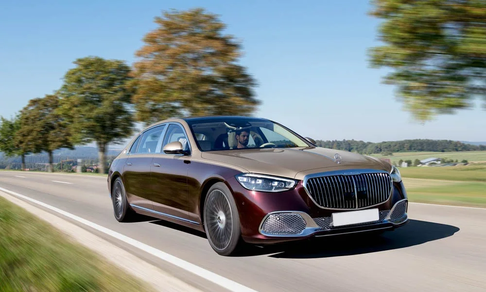 Фото Mercedes-Benz S-Class Maybach — вид спереди, фото 9. Кузов в коричневом цвете: рисунок оптики и решётки задаёт узнаваемое «лицо» модели. Рисунок ходовых огней — подпись модели, по нему её узнают в потоке Mercedes-Benz S-Class Maybach — вид спереди, фото 9