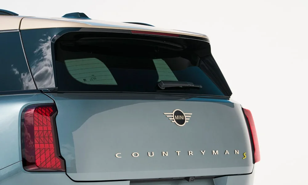 Фото MINI Countryman (2024) — вид сзади, фото 7. Корма в синем цвете: графика фонарей и пластика пятой двери. Насадки выхлопа или их имитация внизу бампера различают версии MINI Countryman (2024) — вид сзади, фото 7