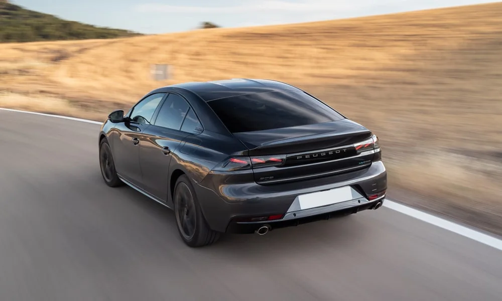 Фото Peugeot 508 (2024) — вид сзади, фото 2. Графика фонарей, бампер и оформление пятой двери. Насадки выхлопа или их имитация внизу бампера различают версии Peugeot 508 (2024) — вид сзади, фото 2
