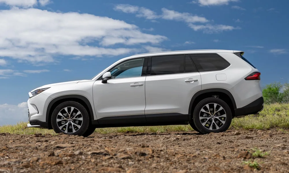 Фото Toyota Grand Highlander (2024) — вид сбоку. Белый кузов в профиль — пропорции, высота посадки и дизайн дисков Toyota Grand Highlander (2024) — вид сбоку