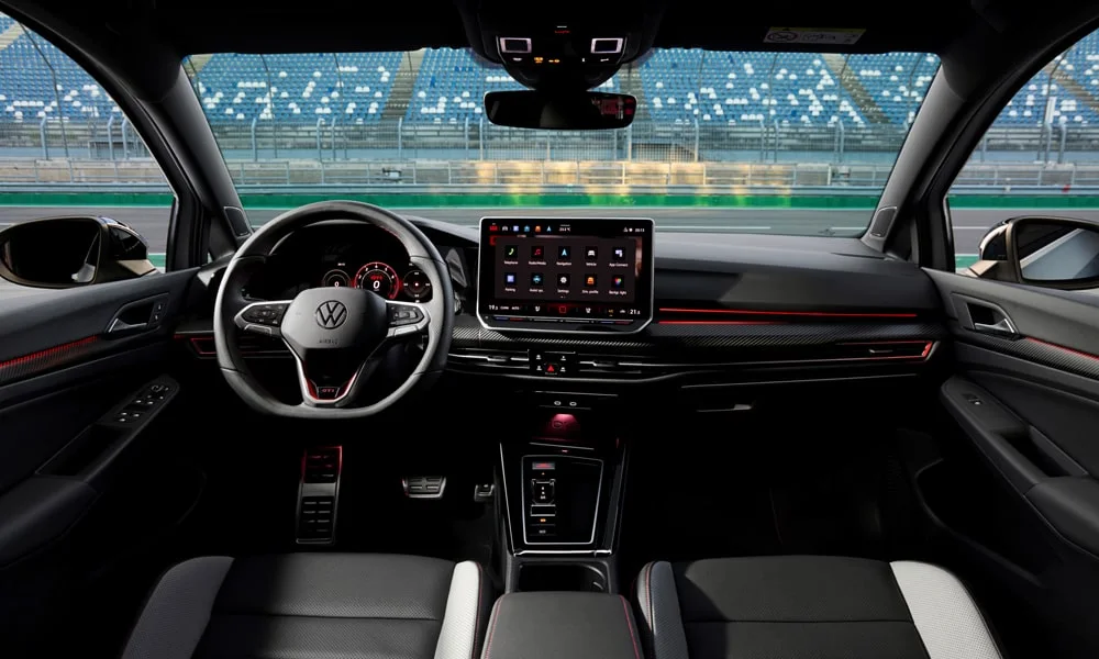 Фото Volkswagen Golf GTI (2024) — интерьер, фото 3. Общий план салона: архитектура панели, консоль и кресла. Уровень отделки читается по стыкам панелей и мягким поверхностям в зонах касания Volkswagen Golf GTI (2024) — интерьер, фото 3